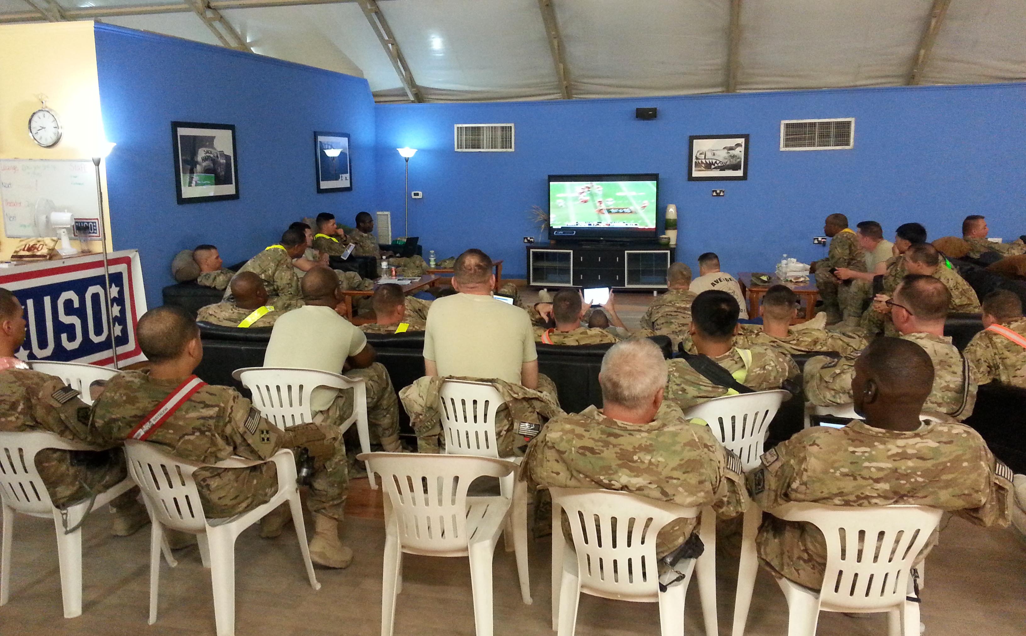 Troops gather at USO Kandahar in Afghanistan to watch football, courtesy of NFL Game Pass. USO photos by Daniel Wood