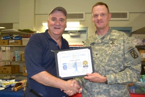 George Barton receives a certificate of appreciation for his USO volunteerism at welcome home events from Army Brig. Gen. Michael Howard on July 15 in Fort Drum, N.Y. USO photo 