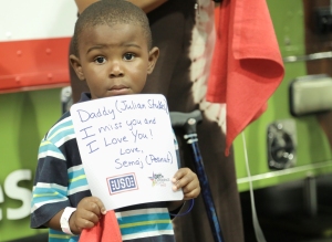 The son of a deployed service member sends a message to his dad at the Mobile USO at the BET Experience at the Los Angeles Convention Center in late June. USO photo by Eric Brandner