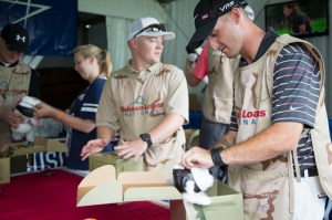 Marine Staff Sgt. Tyler Barnes, right, stationed at Marine Corps Base Quantico, Va., assembles a deployment kit for military kids. USO photo