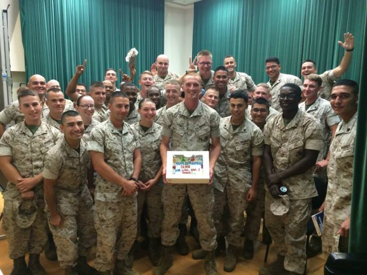Marines smile with a birthday cake at a USO Center on Okinawa, Japan. USO photo