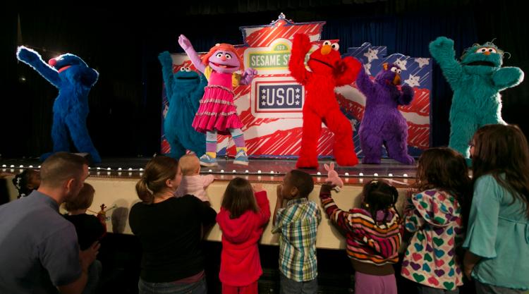 Grover, Cookie Monster, Katie, Elmo, Honker and  Rosita sing and dance for service members and their kids during The Sesame Street/USO Experience for Military Families which kicked off April 7, 2012 at Scott Air Force Base. (USO photo by Fred Greaves)