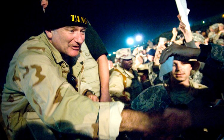 Comedian Robin Williams greets troops during a 2007 USO Chairman's Holiday Tour stop at Camp Arifjan, Kuwait, on Dec. 17, 2007. Photo by Chad J. McNeeley/Courtesy of the Department of Defense