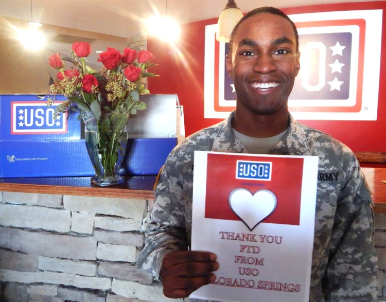 A soldier holds up a sign at USO Colorado Springs. USO photo