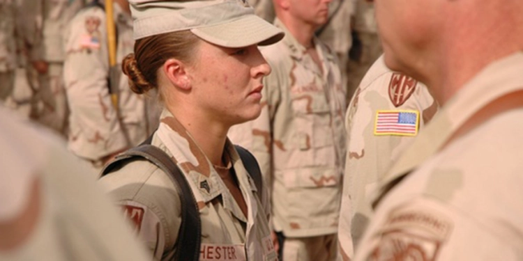 Sgt. Leigh Ann Hester stands at attention before receiving the Silver Star on June 16, 2005, at Camp Liberty, Iraq. DOD photo