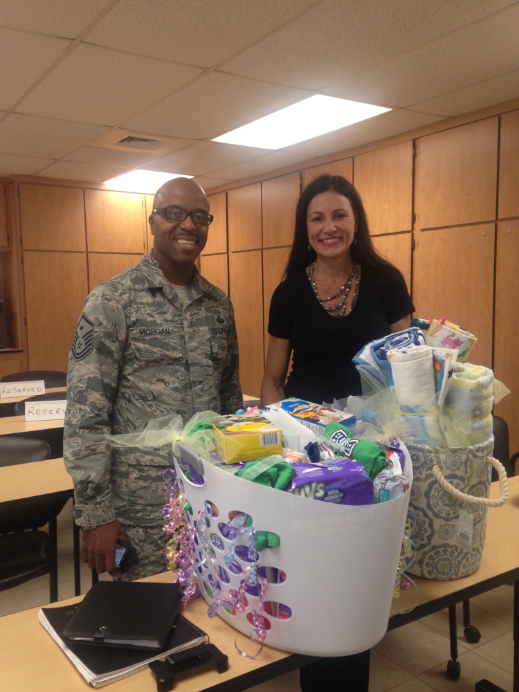 USO Arizona Center Director Tara Mogan poses with the baskets with Staff Sgt. Hoffman's commanding officer.