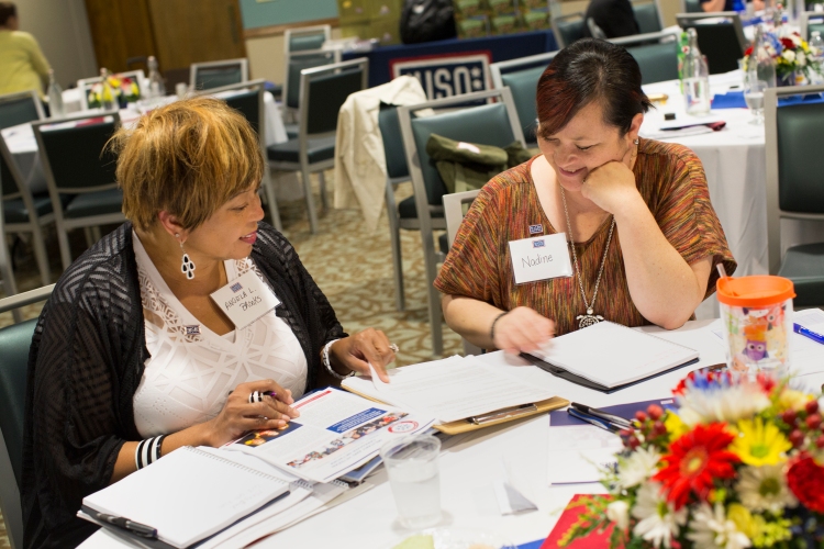 Angela Brooks, left, chats with another USO Caregivers Seminar attendee at Fort Leonard Wood, Missouri, last month. USO photo by Sandi Moynihan