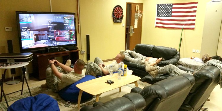 Troops play video games - part of their USO2GO shipment - and use other USO2GO gear in Qatar. Courtesy photo